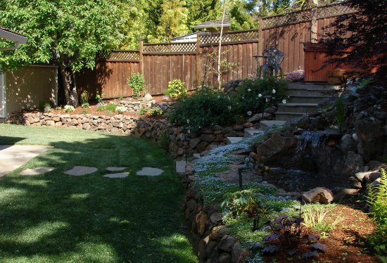 Lawn with Moss Rock Retaining Wall 