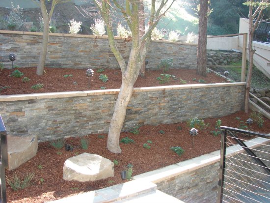 Retaining Wall with Ledge Stone Facade and Stone Wall Cap 